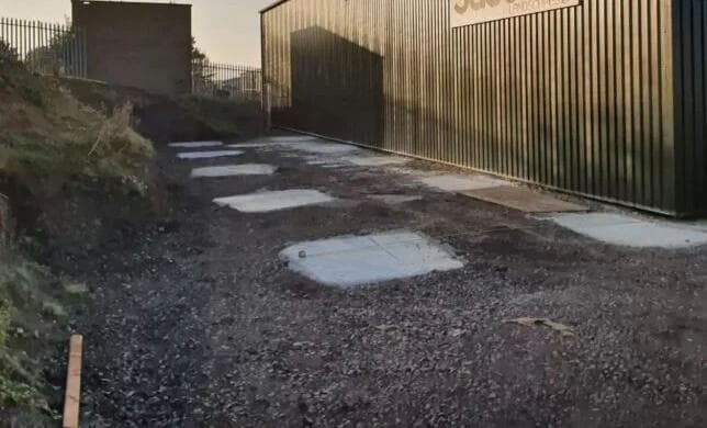 Concrete pad foundations set out and poured for a steel warehouse extension